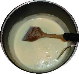 Pour the egg mix into the pot of hot milk